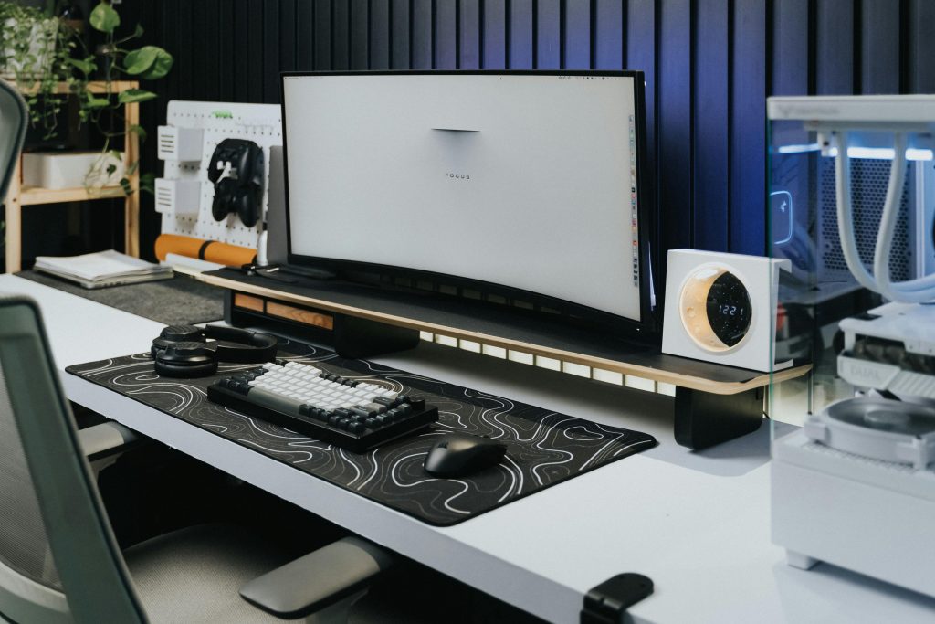 A desk with a computer monitor and a keyboard